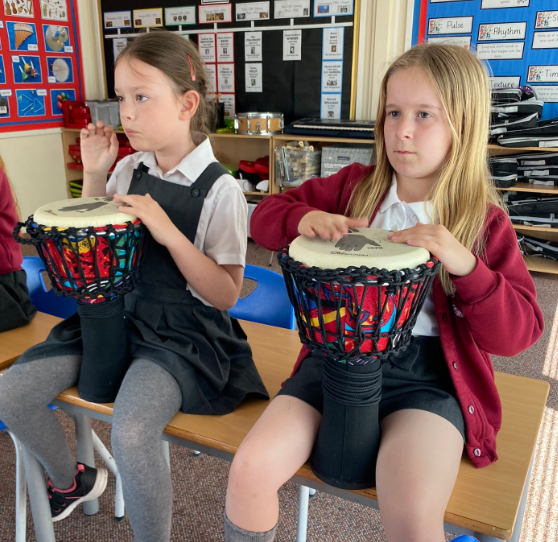 pupils playing Djembe drums